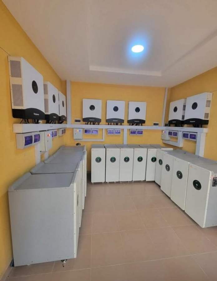 Commercial-scale battery storage room with multiple inverter and battery units installed and wired