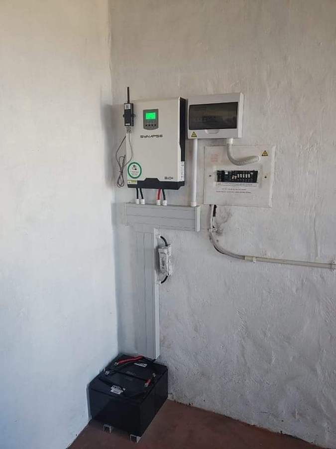 Technician reviewing a monitored inverter installation